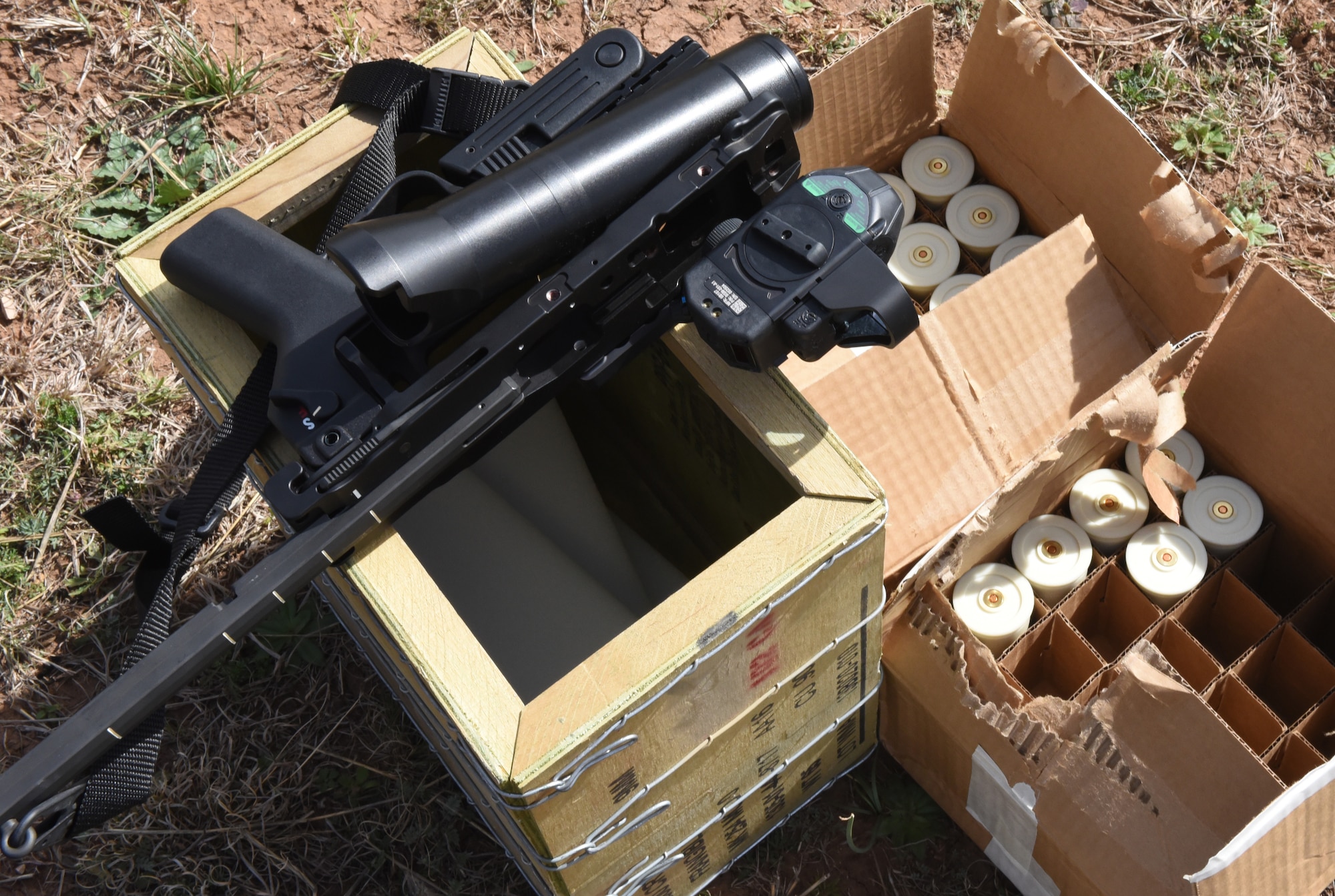 An M320 grenade launcher rests on a crate with ammunition for a demonstration at the San Angelo Police Department firing range, Texas, Feb. 15, 2019. During the demo Goodfellow members used pellet rounds, a sponge round and other non-lethal rounds. (U.S. Air Force photo by Airman 1st Class Isiah Jacobs/Released)
