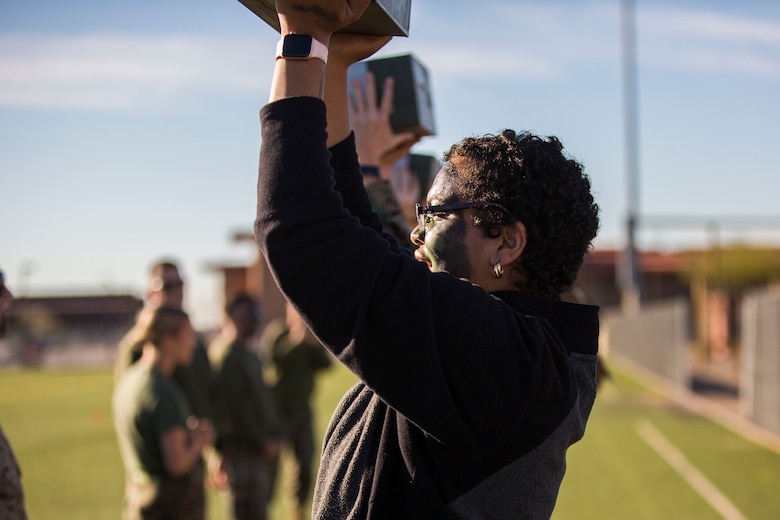 U.S. Marines assigned to Marine Aviation Logistics Squadron (MALS) 13 and their spouses participate in Jane Wayne Day at Marine Corps Air Station (MCAS) Yuma Jan. 25, 2019. Jane Wayne Day consisted of applying camouflage paint, getting some "drill instructor time", conducting a modified combat fitness test (CFT), going through the Obstacle Course, learning a few Marine Corps Martial Arts Program (MCMAP) techniques, and shooting the Beretta M9 Pistol. Jane Wayne Day is designed to give the spouses a little insight on some of the things their Marine does while having fun. (U.S. Marine Corps photo by Cpl. Sabrina Candiaflores)