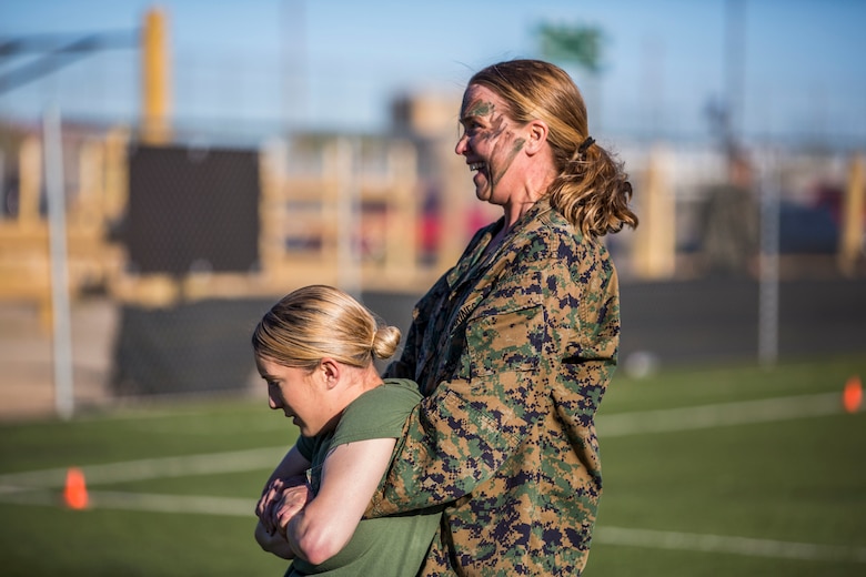 U.S. Marines assigned to Marine Aviation Logistics Squadron (MALS) 13 and their spouses participate in Jane Wayne Day at Marine Corps Air Station (MCAS) Yuma Jan. 25, 2019. Jane Wayne Day consisted of applying camouflage paint, getting some "drill instructor time", conducting a modified combat fitness test (CFT), going through the Obstacle Course, learning a few Marine Corps Martial Arts Program (MCMAP) techniques, and shooting the Beretta M9 Pistol. Jane Wayne Day is designed to give the spouses a little insight on some of the things their Marine does while having fun. (U.S. Marine Corps photo by Cpl. Sabrina Candiaflores)