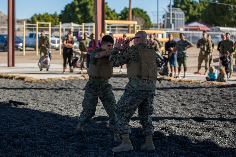 U.S. Marines assigned to Marine Aviation Logistics Squadron (MALS) 13 and their spouses participate in Jane Wayne Day at Marine Corps Air Station (MCAS) Yuma Jan. 25, 2019. Jane Wayne Day consisted of applying camouflage paint, getting some "drill instructor time", conducting a modified combat fitness test (CFT), going through the Obstacle Course, learning a few Marine Corps Martial Arts Program (MCMAP) techniques, and shooting the Beretta M9 Pistol. Jane Wayne Day is designed to give the spouses a little insight on some of the things their Marine does while having fun. (U.S. Marine Corps photo by Cpl. Sabrina Candiaflores)