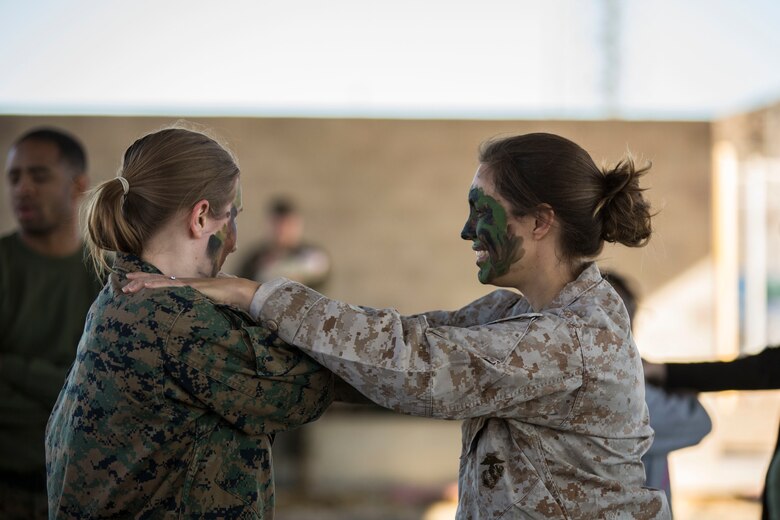 U.S. Marines assigned to Marine Aviation Logistics Squadron (MALS) 13 and their spouses participate in Jane Wayne Day at Marine Corps Air Station (MCAS) Yuma Jan. 25, 2019. Jane Wayne Day consisted of applying camouflage paint, getting some "drill instructor time", conducting a modified combat fitness test (CFT), going through the Obstacle Course, learning a few Marine Corps Martial Arts Program (MCMAP) techniques, and shooting the Beretta M9 Pistol. Jane Wayne Day is designed to give the spouses a little insight on some of the things their Marine does while having fun. (U.S. Marine Corps photo by Cpl. Sabrina Candiaflores)