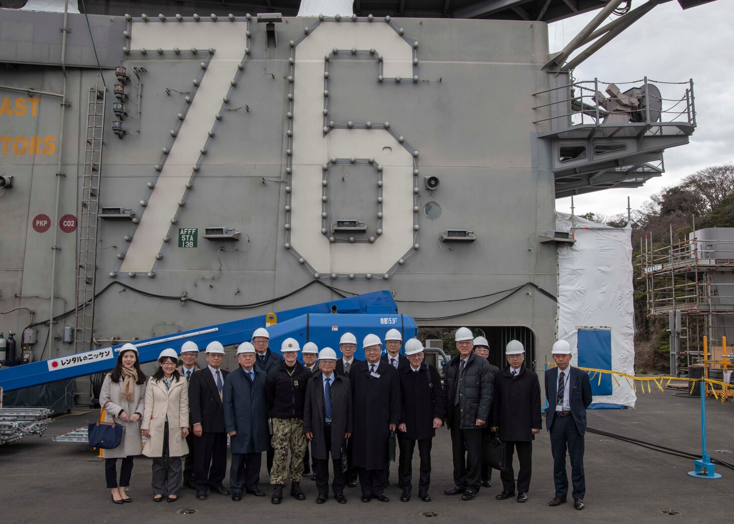 YOKOSUKA (Feb. 21, 2019) Iwakuni Chamber of Commerce and Industry pose for a group photo on the flight deck aboard the Navy's forward-deployed aircraft carrier, USS Ronald Reagan (CVN 76). Ronald Reagan, the flagship of Carrier Strike Group 5, provides a combat-ready force that protects and defends the collective maritime interests of its allies and partners in the Indo-Pacific region.