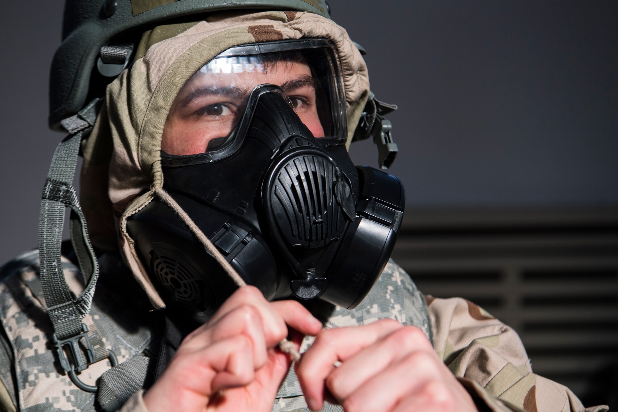 U.S. Air Force Airman 1st Class Juan Rubio, 86th Airlift Wing Command Post controller, dons his chemical gear during an 86th Wing Staff Agencies pre-exercise training at Ramstein Air Base, Germany, Feb. 13. 2019. (U.S. Air Force photo by Airman 1st Class Milton Hamilton)