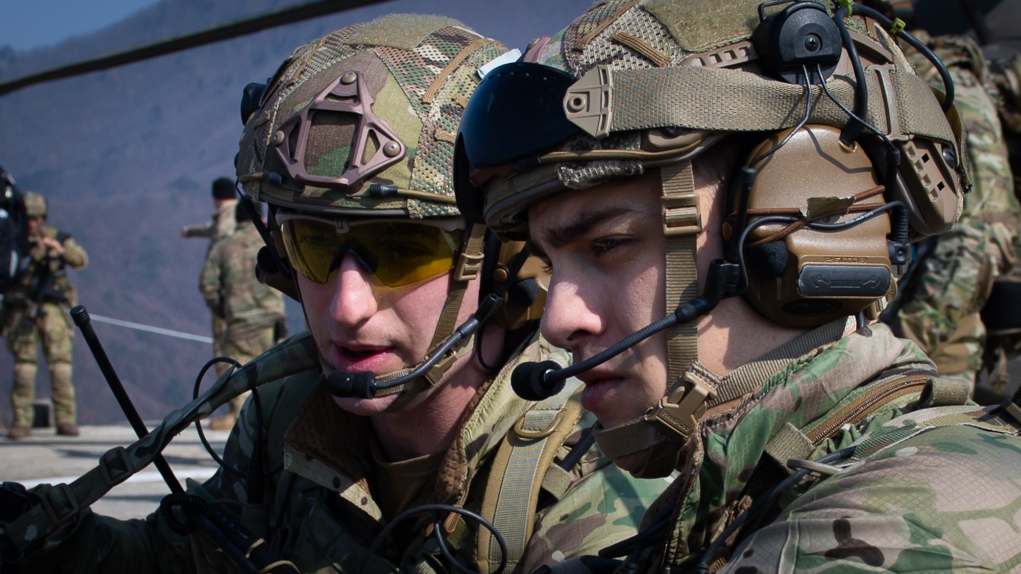 U.S. Air Force Staff Sgt. Samuel Stinebrook, a joint terminal attack controller assigned to the 604th Air Support Operations Squadron, right, coordinates with a teammate during close air support training at the Pilsung Range in Gangwan Province, Republic of Korea, Feb. 14, 2018.