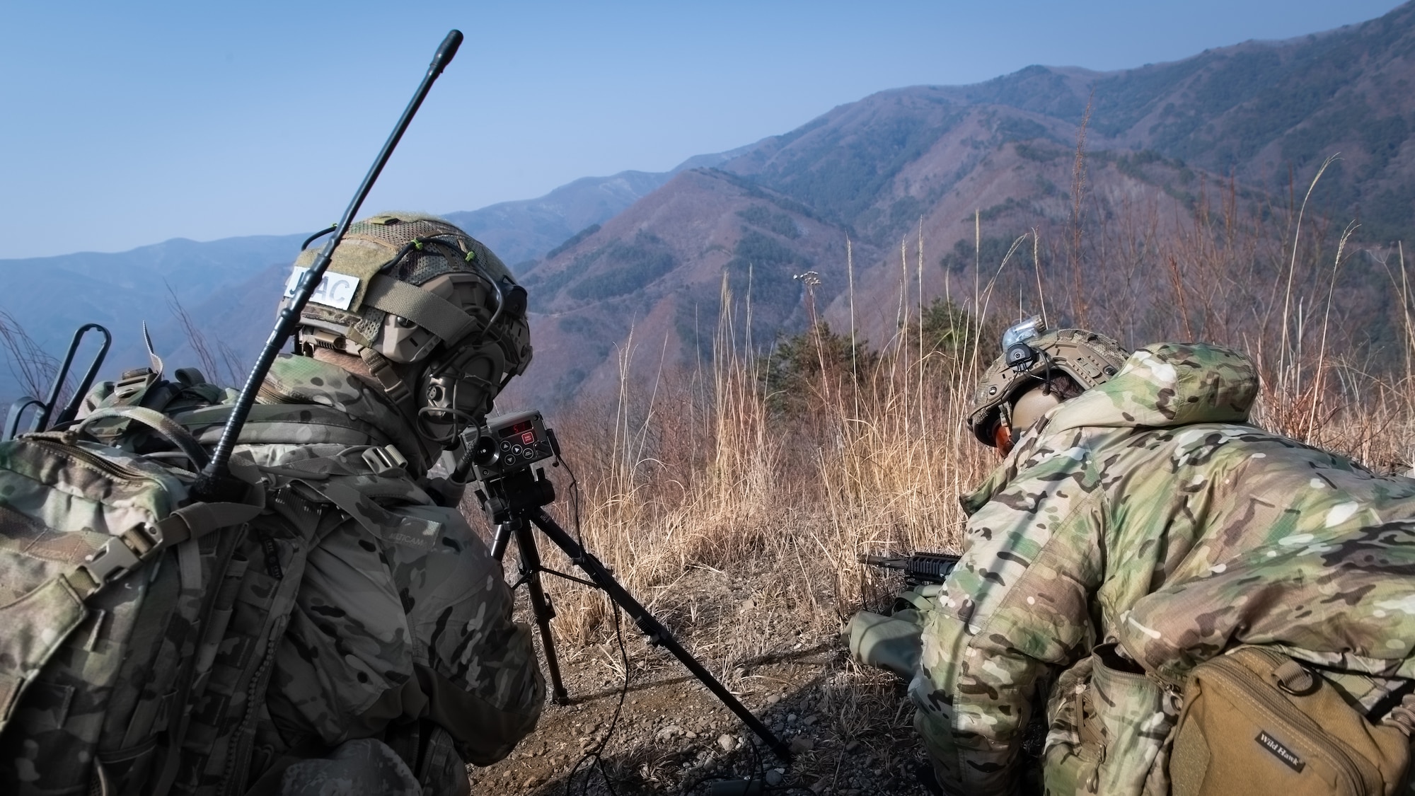 Two U.S. Air Force joint terminal attack controllers utilize a laser designator designed to designate a target during training at Pilsung Range in Gangwan Province, Republic of Korea, Feb. 14, 2019.