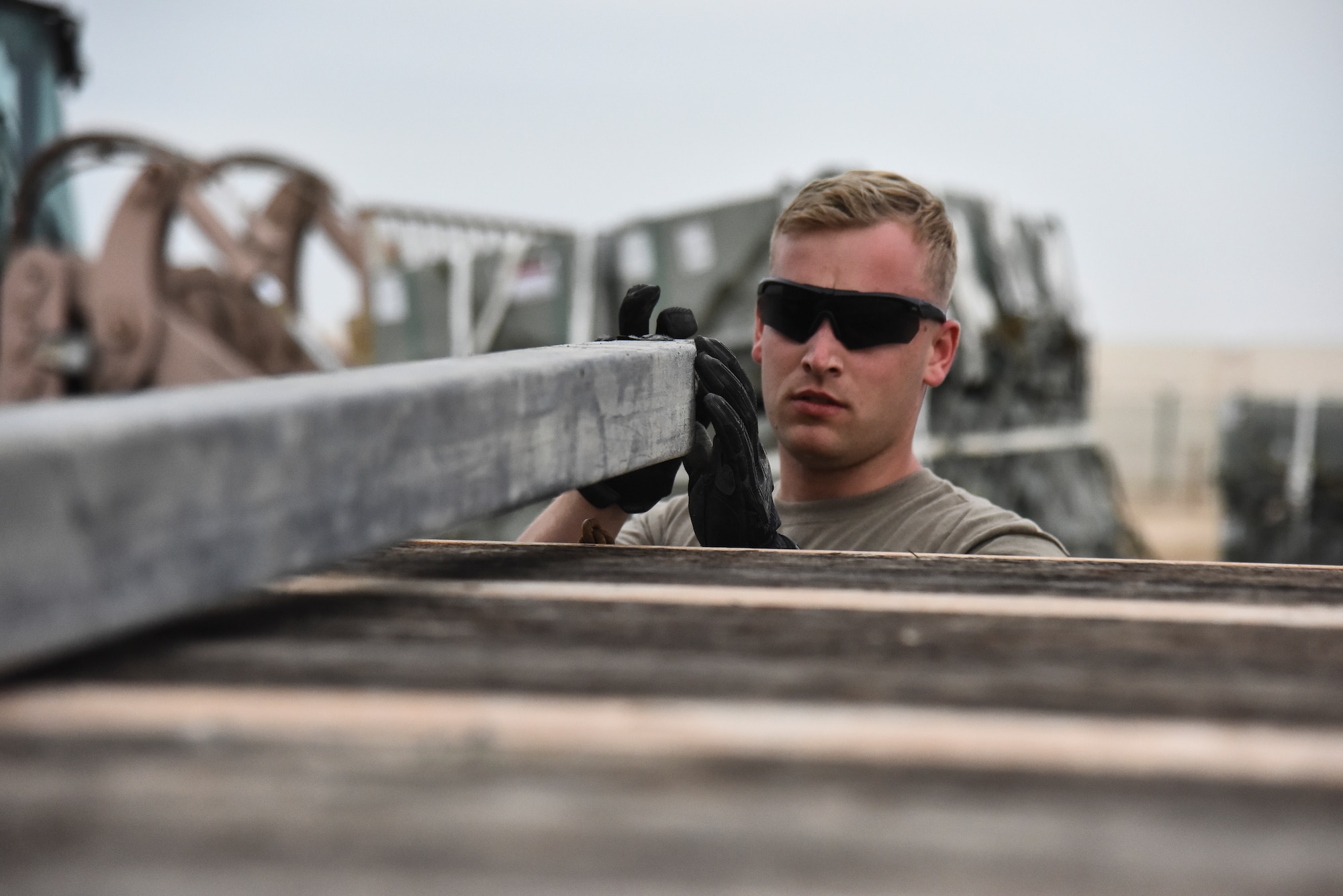 Senior Airman Christopher Madonna, 380th Expeditionary Maintenance Squadron munitions journeyman, aligns the dunnage at Al Dhafra Air Base, United Arab Emirates, Feb. 15, 2019. The munitions flight is responsible for preparing and loading munitions on aircraft, inspecting munitions for serviceability and conducting inventories and correct discrepancies. (U.S. Air Force photo by Senior Airman Mya M. Crosby)