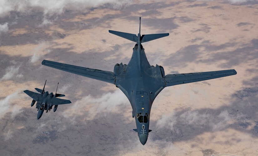 A U.S. Air Force B-1B Lancer bomber and F-15E Strike Eagle fly in formation during Joint Air Defense Exercise 19-01, Feb. 19, 2019. The aircraft participated with regional partners to test objective-based command and control actions during the exercise. JADEX is an opportunity to test and improve combined air and missile defense capabilities and ensure Joint Coalition partners are prepared to defend against external threats with a variety of capabilities and assets. (U.S. Air Force photo by Staff Sgt. Clayton Cupit)