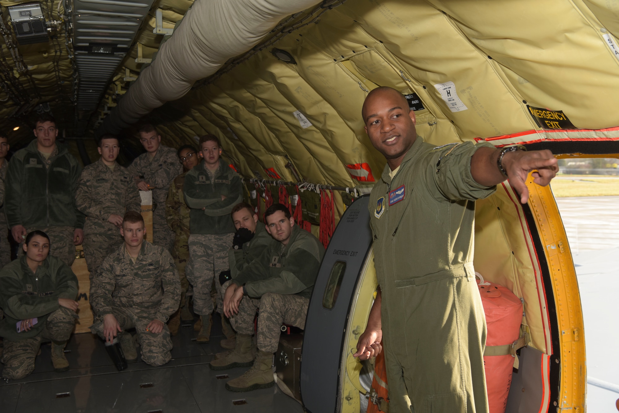 U.S. Air Force Staff Sgt. Kevin Satberry, 351st Air Refueling Squadron boom operator, gives a safety brief to First-Term Airmen before their incentive flight on a KC-135 Stratotanker at RAF Mildenhall, England, Feb. 2, 2019. Satberry uses these opportunities to answer any questions or concerns young Airmen may have before their first flight on a military aircraft. (U.S. Air Force photo by Airman 1st Class Alexandria Lee)