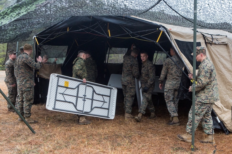 U.S. Marines with Headquarters Battalion, 2nd Marine Division, set up a combat operations center during Tent Exercise 1-19 on Camp Lejeune, N.C., Feb. 4-15, 2019. The two-week-long exercise tested 2nd Marine Division's ability to rapidly break down and re-establish a combat operations center in a field environment, which is essential to the effectiveness and survivability of the command element. (U.S. Marine Corps photo by Cpl. Liah A. Smuin)