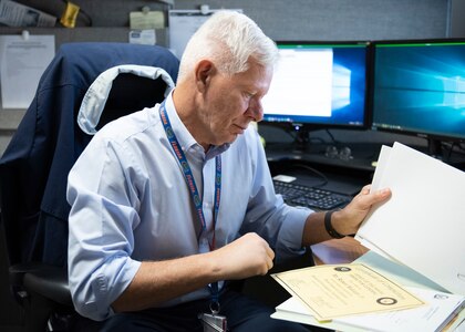 Naval Surface Warfare Center Panama City Division Command Investigations Office investigator Robert L. Malouin, Jr. reviews his certificate of completion that led to his certification as Inspector General Hotline Advanced Investigator. Malouin’s achievement makes him a part of a small group of investigators across the Naval Sea Systems Command enterprise to obtain the distinction.