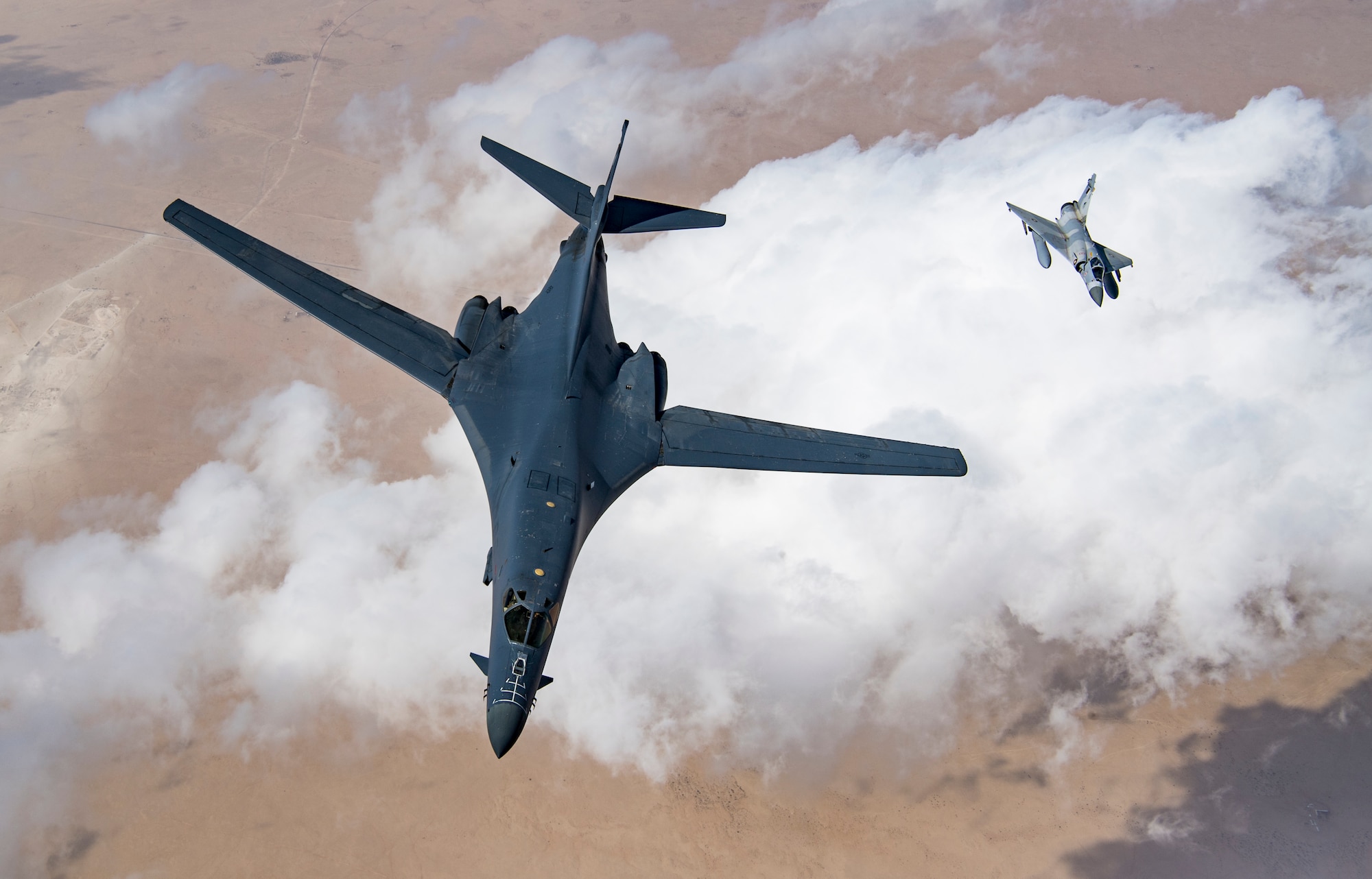 A U.S. Air Force B-1B Lancer bomber and a Qatari Mirage 2000 fly in formation during Joint Air Defense Exercise 19-01, Feb. 19, 2019. The aircraft participated with regional partners to test objective-based command and control actions during the exercise. (U.S. Air Force photo by Staff Sgt. Clayton Cupit)
