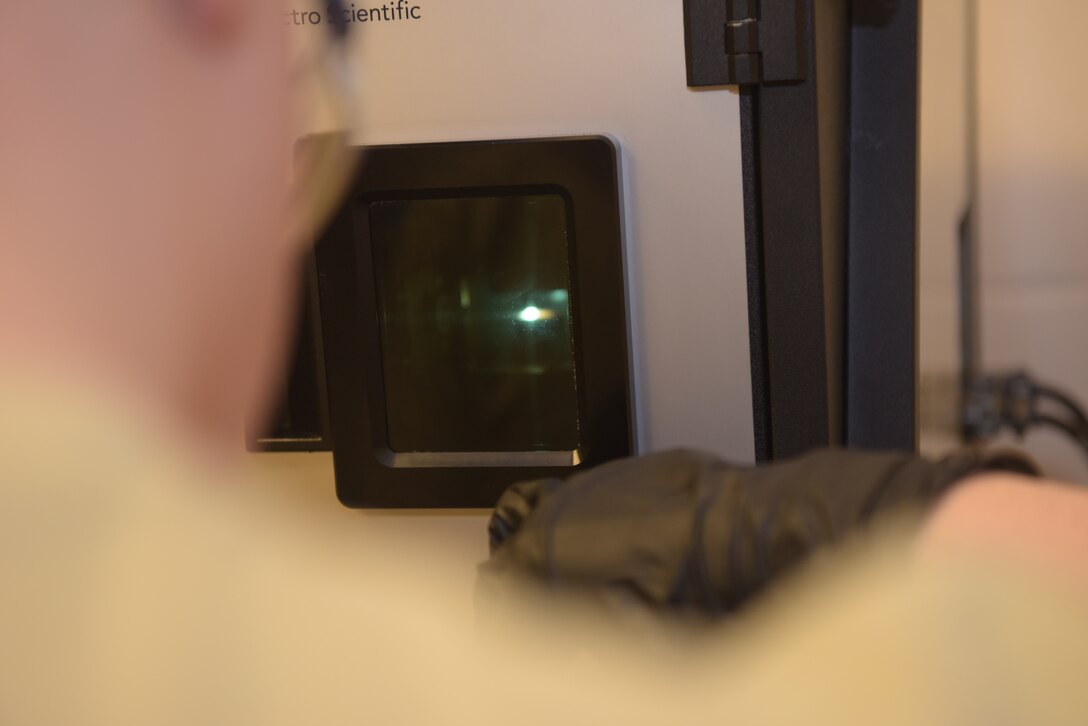 U.S. Air Force Senior Airman Tyler Lane, 100th Maintenance Squadron non-destructive inspection apprentice, tests sample oil collections with the Oil Analysis Program machine at RAF Mildenhall, England, Feb. 7, 2019. The testing of sample oil helps standardize the OAP unit to create a standard to compare to. (U.S. Air Force photo by Airman 1st Class Alexandria Lee)