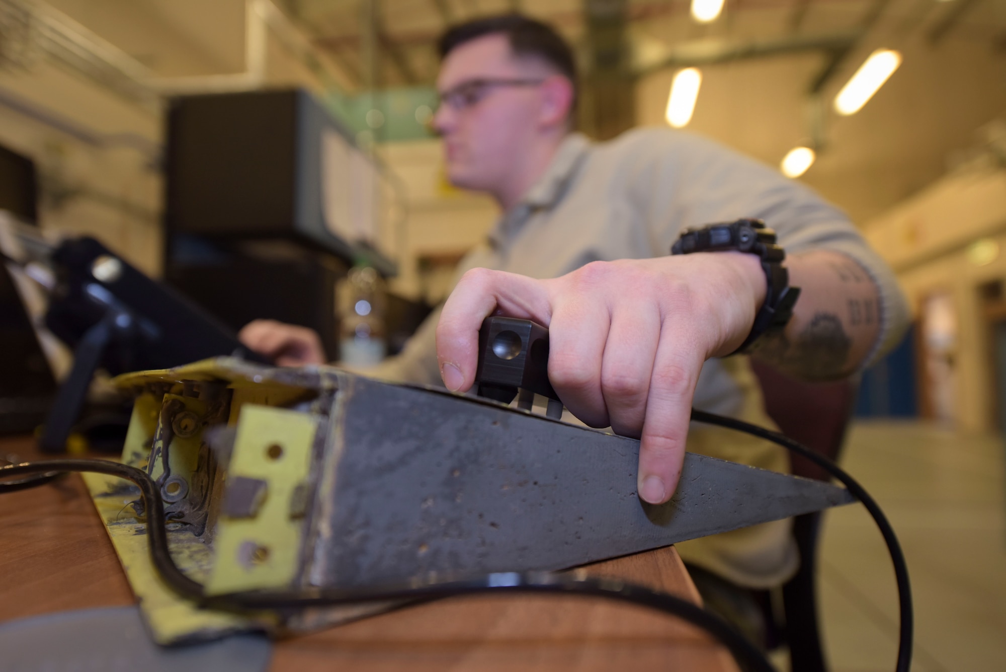 U.S. Air Force Airman 1st Class Alex Dixson, 100th Maintenance Squadron non-destructive inspection apprentice, performs a bond test on a sample panel using ultrasonic inspection at RAF Mildenhall, England, Feb. 7, 2019. The tool is used to check for separation in parts, finding potential weak points throughout the panels of an aircraft.  (U.S. Air Force photo by Airman 1st Class Alexandria Lee)