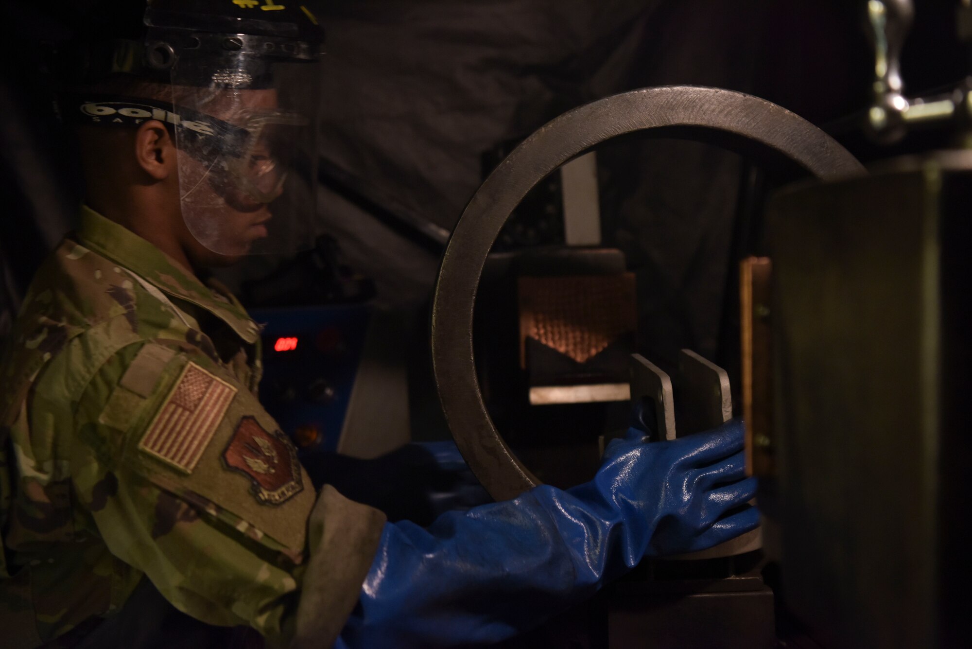 U.S. Air Force Airman 1st Class Clarence Bennett, 100th Maintenance Squadron non-destructive inspection apprentice, performs a magnetic particle inspection on a sample part, at RAF Mildenhall, England, Feb. 7, 2019. Magnetic particle inspections identify stress fatigue fractures on a high variety of parts, varying from bolts, tow bars and other supporting aerospace ground equipment. (U.S. Air Force photo by Airman 1st Class Alexandria Lee)
