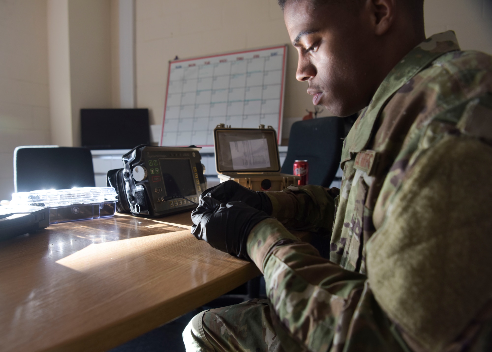 U.S. Air Force Airman 1st Class Clarence Bennett, 100th Maintenance Squadron non -destructive inspection apprentice, calibrates an ultrasonic unit to varying shim sizes testing thickness at RAF Mildenhall, England, Feb. 7, 2019. A shim is a piece of plastic or metal that is used as a reference standard for how thick the area is being tested. (U.S. Air Force photo by Airman 1st Class Alexandria Lee)