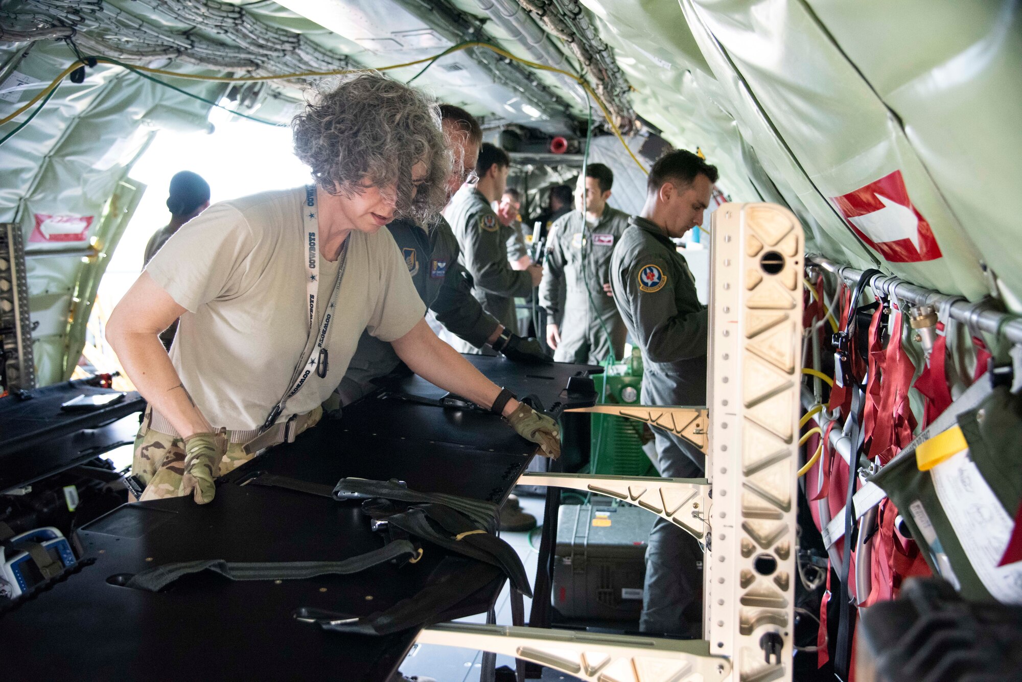 U.S. Air Force Capt. Tracy Minke, 18th Aeromedical Evacuation Squadron flight nurse, sets-up a specialized litter rack on a 384th Air Refueling Squadron KC-135 Stratotanker during an AE exercise near Kadena Air Base, Japan, Feb. 19, 2019. AE teams use specialized gear to safely secure critical care patients and maximize space on an aircraft, convert aircraft power to their medical equipment, and protect medics and patients in the event of an in-flight emergency. (U.S. Air Force photo by Senior Airman Ryan Lackey)