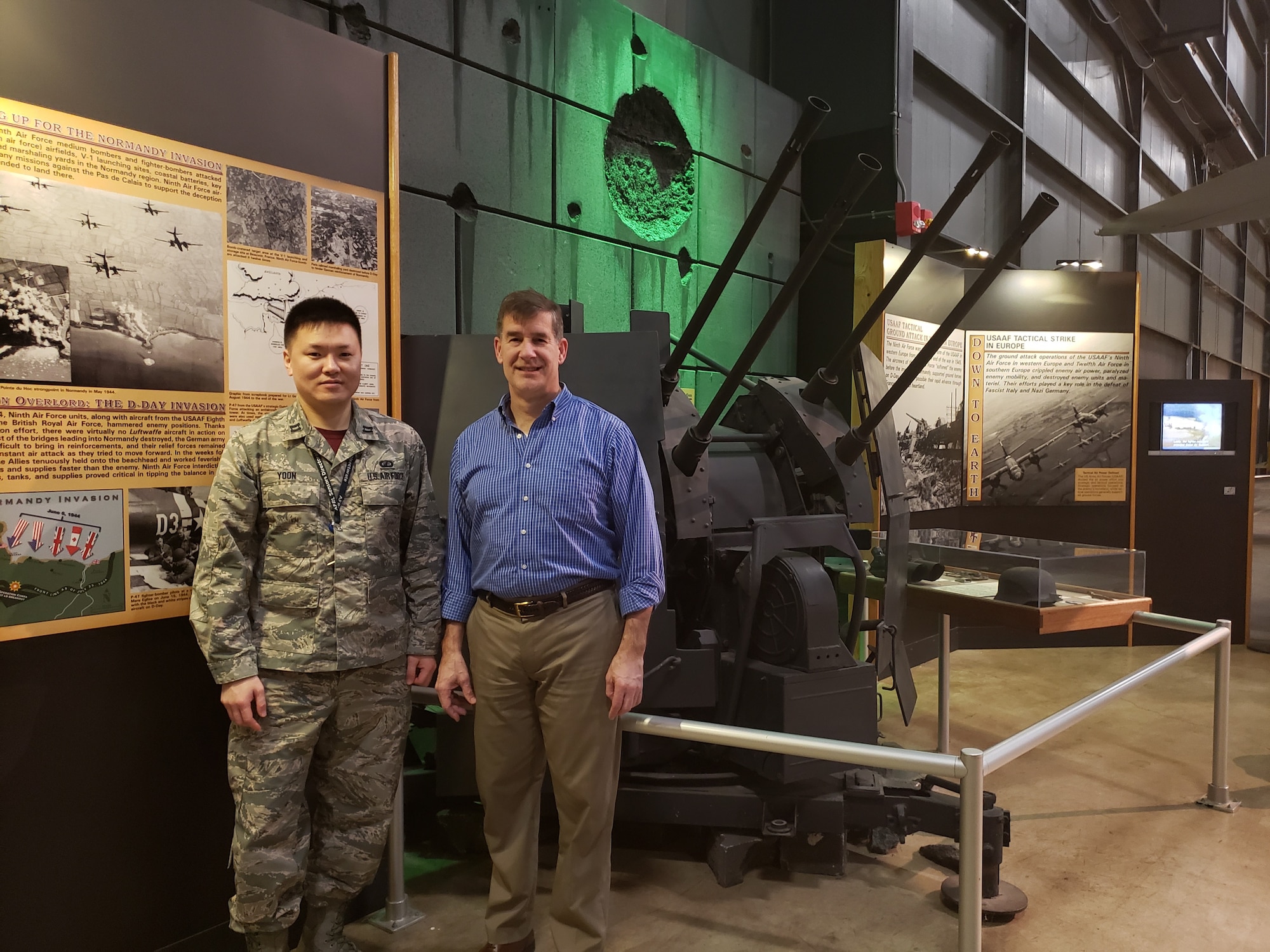 Capt. Yongjun Yoon, an RF sensing engineer from the RF Technology Branch at AFRL's Sensors Directorate, and David Sobota, with the Sensors Effects and Analysis Branch, in front of a ZPU-4 Soviet-built anti-aircraft gun at the National Museum of the United States Air Force.