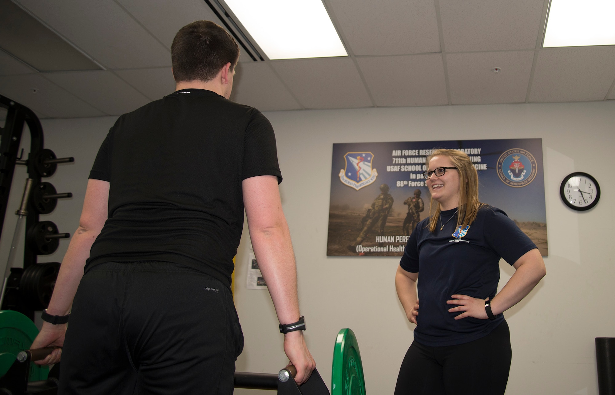 Hannah Kohne, a contractor at the 711th Human Performance Wing, takes Staff Sgt. Alan Gagnon through an exercise routine as a part of the Function Bridge Fitness Study at Wright Patterson Air Force Base, Feb. 14, 2019.