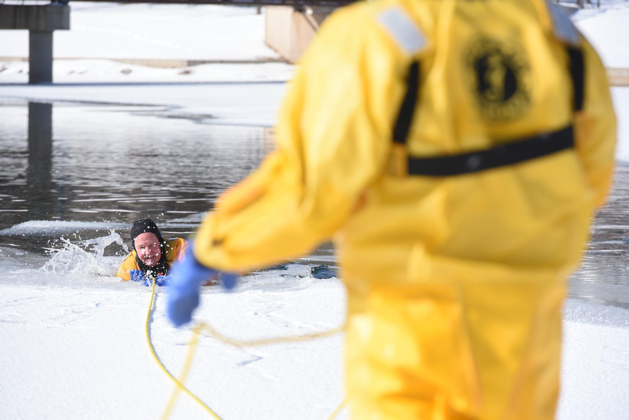 Hunter Harlan, a Rapid City Fire Department ice rescue instructor, demonstrates how a person can be saved should they become the victim of an ice water accident at Canyon Lake in Rapid City, S.D., Feb. 12, 2019. The instructors stressedthe importance of not only keeping calm during an ice water emergency but also making sure the rescuers protect themselves. (U.S. Air Force photo by Senior Airman Michella Stowers)