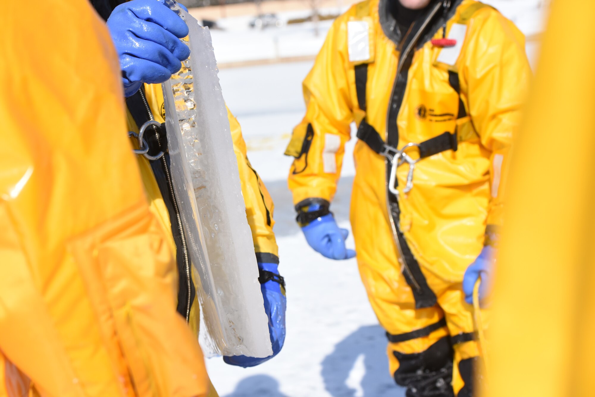 Brian Povandra, a Rapid City Fire Department ice rescue instructor, holds up a fragment of ice from the lake to show Airmen from the 28th Civil Engineer Squadron Fire Protection Flight the thickness of the ice they were standing on at CanyonLake in Rapid City, S.D., Feb. 12, 2019. The thickness of the ice on the lake that day ranged from 2 to 10 inches. (U.S. Air Force photo by Senior Airman Michella Stowers)