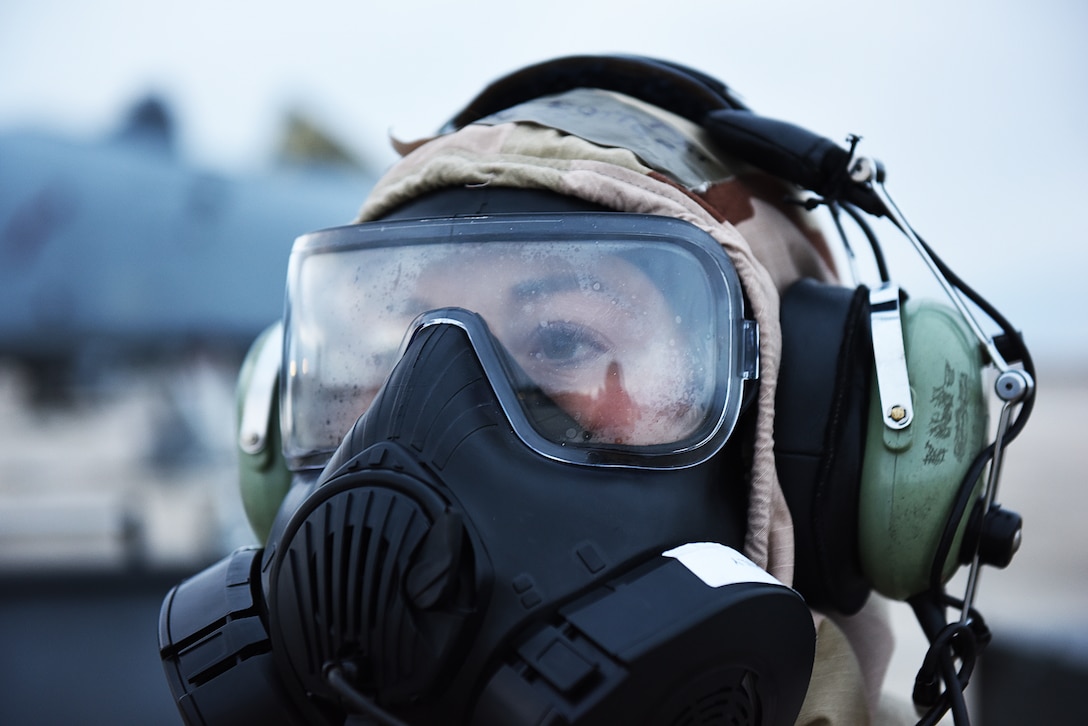 Airmen from the 124th Fighter Wing survey the area around buildings in full protective gear during a major readiness exercise