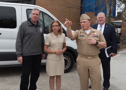Capt. Aaron Peters, NSWC PCD commanding officer, and Ed Stewart (SES), NSWC PCD technical director, show Rep. Debbie Wasserman Schultz and Rep. Neal Dunn the damage that the NSWC PCD sustained after Hurricane Michael hit during a tour of the Naval Support Activity Panama City Feb. 19, 2019.