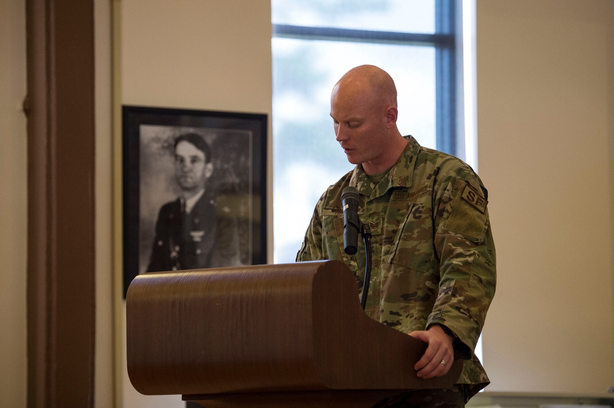 Staff Sgt. Anthony Hayes, 23d Security Forces Squadron (SFS) military working dog handler, reads a decoration during a retirement ceremony, Feb. 21, 2019, at Moody Air Force Base, Ga. Military working dog ZIPPO was assigned to the 325th SFS at Tyndall Air Force Base, Fl. in Nov. 2011, as a patrol/explosive dog. During his eight years on active duty, he’s deployed to Saudi Arabia twice and supported four United States Secret Service missions where he provided security for the President and Vice President of the United States. (U.S. Air Force photo by Senior Airman Janiqua P. Robinson)