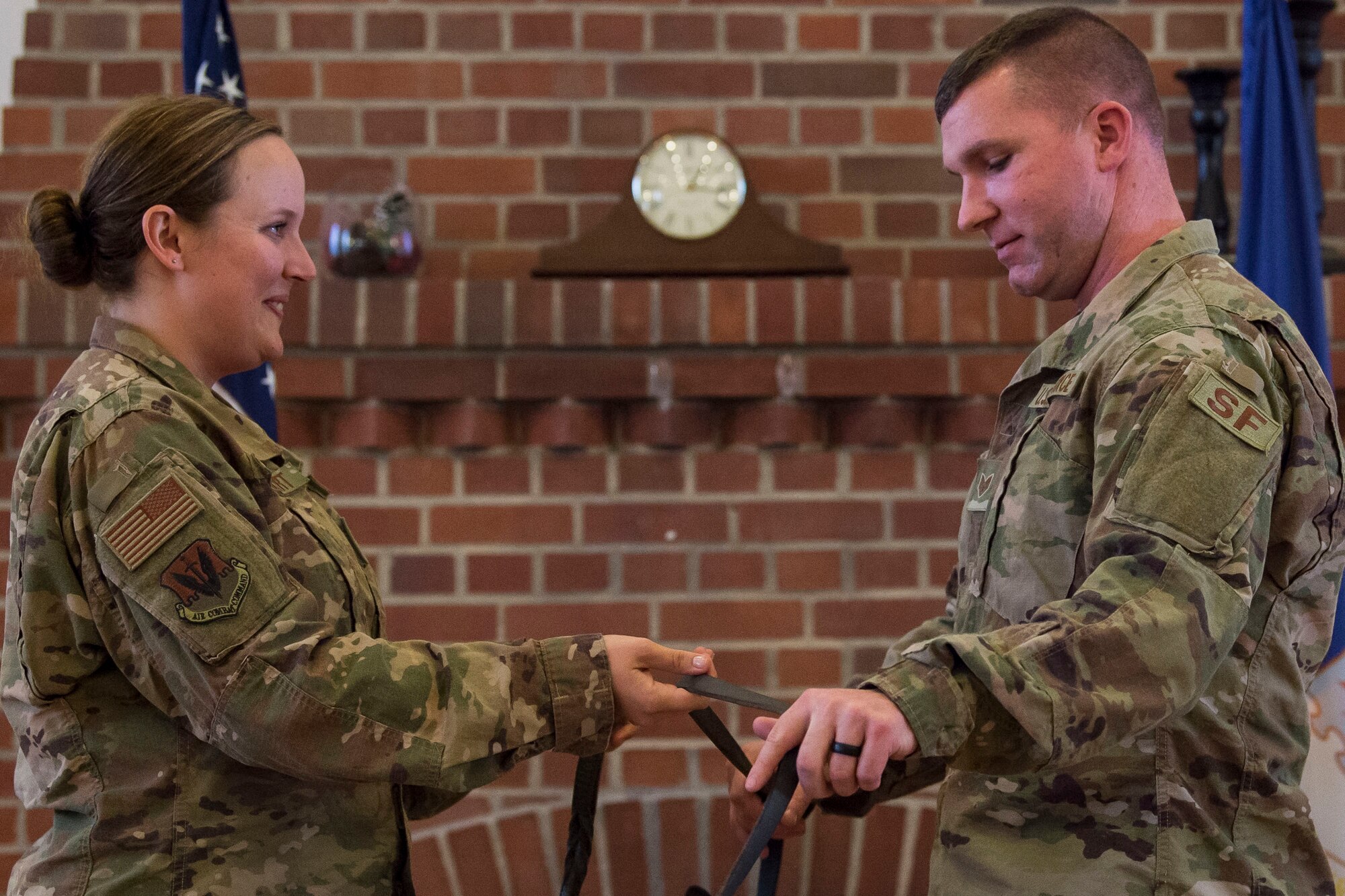Staff Sgt. Lyndsay Gebhart, 23d Security Forces Squadron (SFS) military working dog handler, passes the leash to retired military working dog ZIPPO’s new owner, Tech. Sgt. Corey Rundle, 375th SFS military working dog handler, during a retirement ceremony, Feb. 21, 2019, at Moody Air Force Base, Ga. ZIPPO was assigned to the 325th Security Forces Squadron at Tyndall Air Force Base, Fl. in Nov. 2011, as a patrol/explosive dog. During his eight years on active duty, he’s deployed to Saudi Arabia twice and supported four United States Secret Service missions where he provided security for the President and Vice President of the United States. (U.S. Air Force photo by Senior Airman Janiqua P. Robinson)