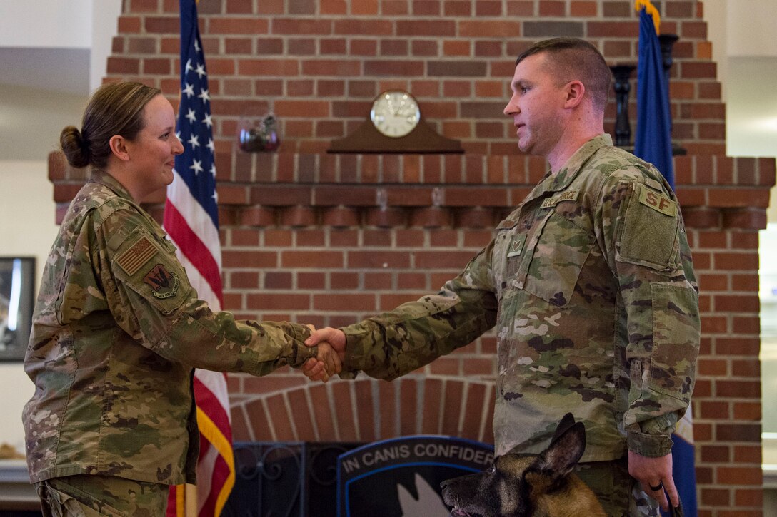 Staff Sgt. Lyndsay Gebhart, 23d Security Forces Squadron (SFS) military working dog handler, relinquishes command of retired military working dog ZIPPO to his new owner, Tech. Sgt. Corey Rundle, 375th SFS military working dog handler, during a retirement ceremony, Feb. 21, 2019, at Moody Air Force Base, Ga. ZIPPO was assigned to the 325th SFS at Tyndall Air Force Base, Fl. in Nov. 2011, as a patrol/explosive dog. During his eight years on active duty, he’s deployed to Saudi Arabia twice and supported four United States Secret Service missions where he provided security for the President and Vice President of the United States. (U.S. Air Force photo by Senior Airman Janiqua P. Robinson)