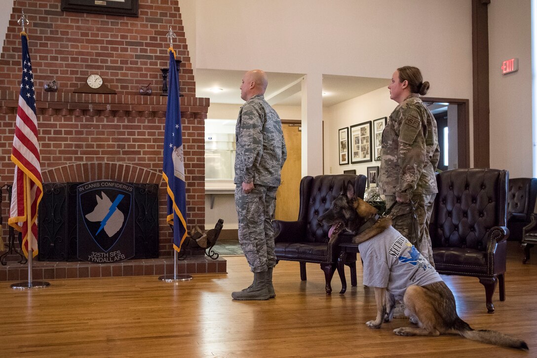 Maj. Daniel Land, 23d Security Forces Squadron (SFS) commander, left, Staff Sgt. Lyndsay Gebhart, 23d SFS military working dog handler, and retired military working dog ZIPPO stand for the national anthem during a retirement ceremony, Feb. 21, 2019, at Moody Air Force Base, Ga. ZIPPO was assigned to the 325th Security Forces Squadron at Tyndall Air Force Base, Fl. in Nov. 2011, as a patrol/explosive dog. During his eight years on active duty, he’s deployed to Saudi Arabia twice and supported four United States Secret Service missions where he provided security for the President and Vice President of the United States. (U.S. Air Force photo by Senior Airman Janiqua P. Robinson)