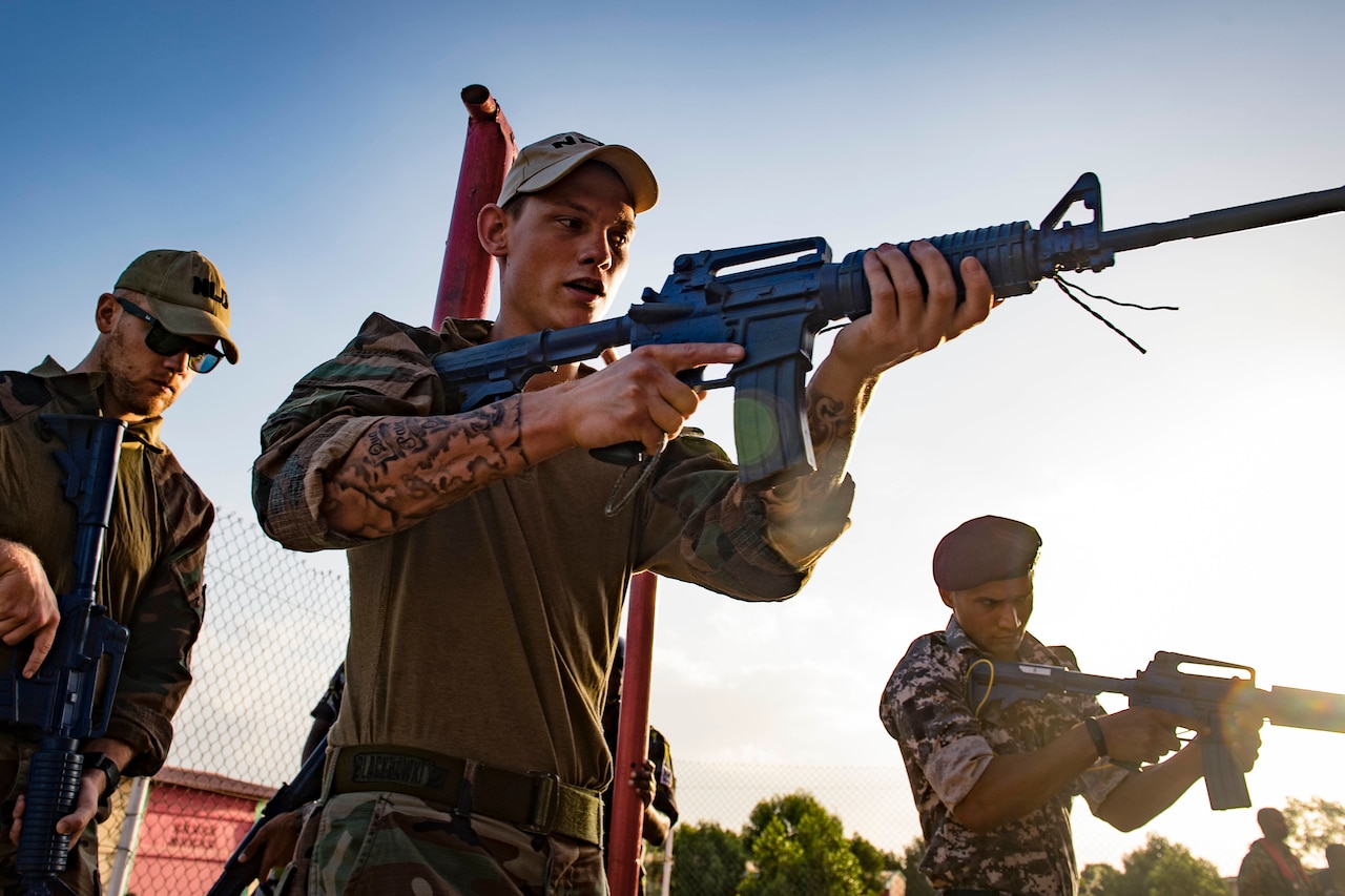 Two men ready their weapons.