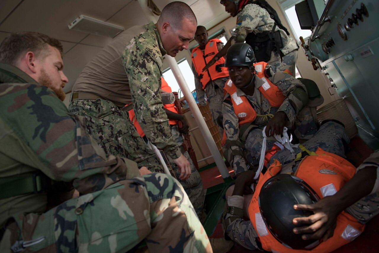 Sailors practice applying bandage.