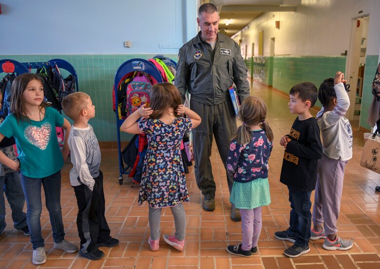 Col. Joseph Campo, 49th Wing commander, speaks with children prior to reading to them, Feb. 21, 2019, at Holloman Elementary School on Holloman Air Force Base, N.M. The elementary schools hosts a ‘mystery reader’ every month for the children to meet. (U.S. Air Force photo by Staff Sgt. Christine Groening)