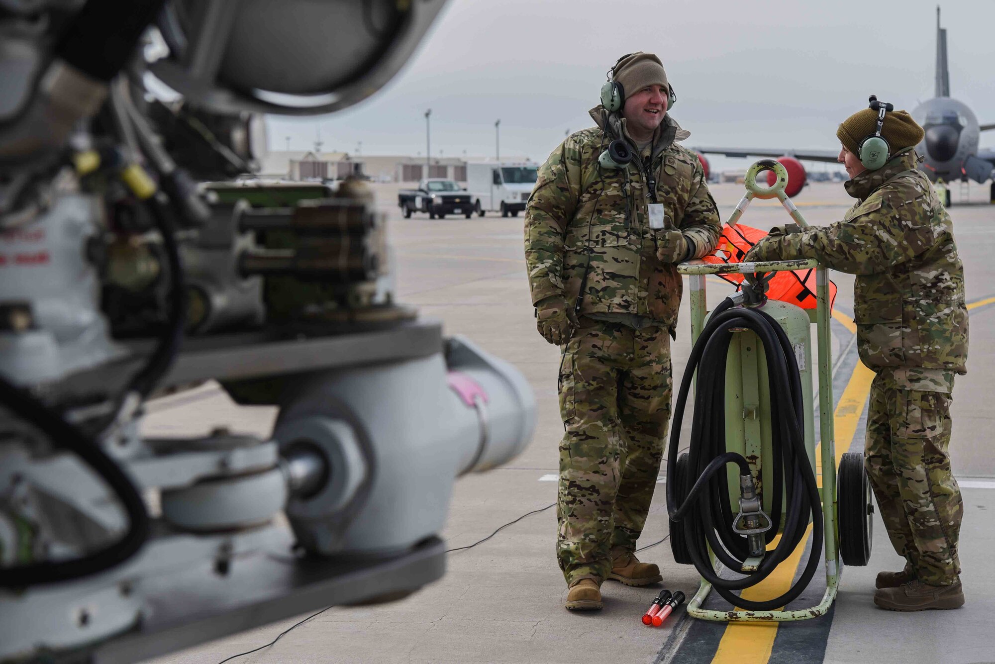 Master Sgt. Arenda Jackson and Master Sgt. Scott Perkins, 931st Aircraft Maintenance Squadron crew chiefs, wait for the KC-46A Pegasus to begin taxiing Feb. 21, 2019, at McConnell Air Force Base, Kan. As a part of the familiarization period with the KC-46, aircrews began procedures for taxiing the aircraft around the airfield.  The next step toward operationally refueling will be a test flight. McConnell will be receiving a 32 additional next-generation tankers for a total of 36 aircraft. (This photo has been altered for security purposes by blurring out identification badges) (U.S. Air Force photo by Airman 1st Class Alexi Myrick)