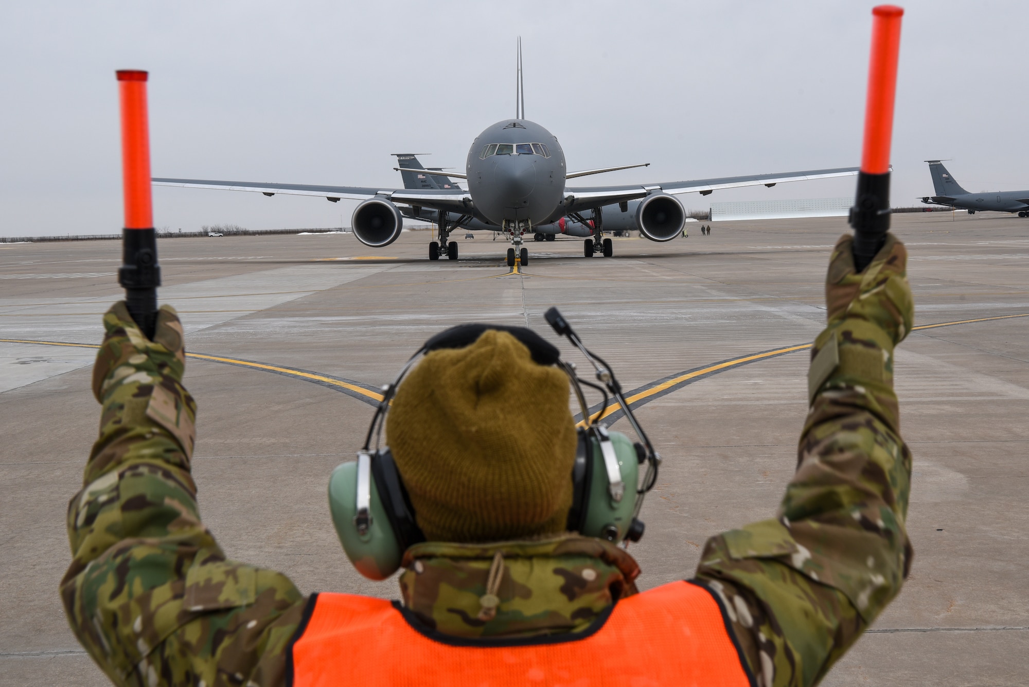 Master Sgt. Arenda Jackson, 931st Aircraft Maintenance Squadron crew chief, marshals the KC-46A Pegasus on the flightline Feb. 21, 2019, at McConnell Air Force Base Kan. The first KC-46 was delivered to McConnell Jan. 25, 2019. The Air Mobility Command will operate 179 KC-46s distributed to multiple bases across the Air Force. The aircraft is equipped for passengers, aeromedical evacuation and cargo capabilities. (U.S. Air Force photo by Airman 1st Class Alexi Myrick)