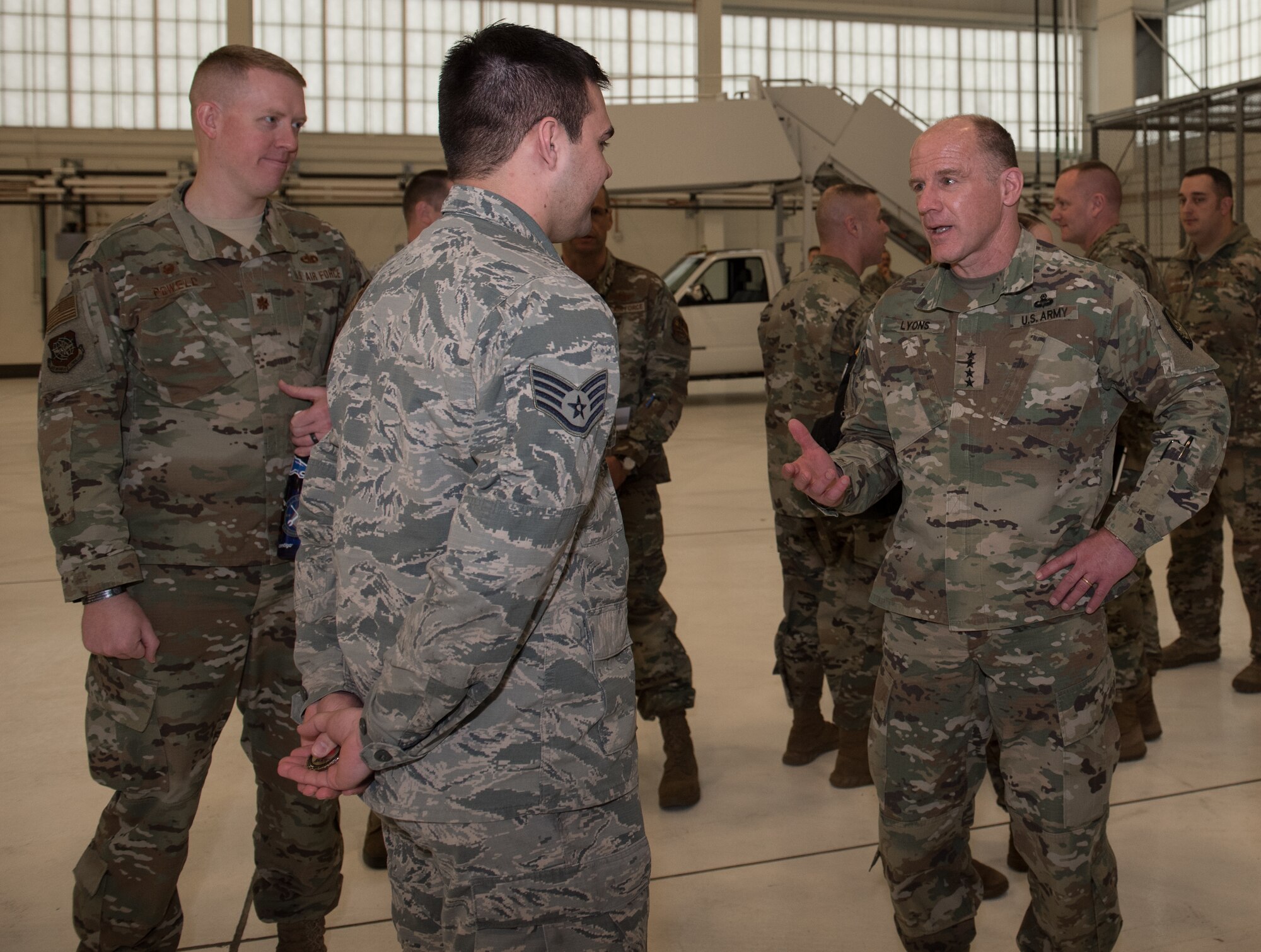 U.S. Army Gen. Stephen R. Lyons, U.S. Transportation Command commander, speaks to Staff Sgt. Austin Barlow, 22nd Maintenance Squadron inspection section journeyman, Feb. 21, 2019, at McConnell Air Force Base, Kan. Lyons coined Airmen assigned to the 22nd Air Refueling Wing and the 931st ARW during his visit. (U.S. Air Force photo by Staff Sgt. David Bernal Del Agua)