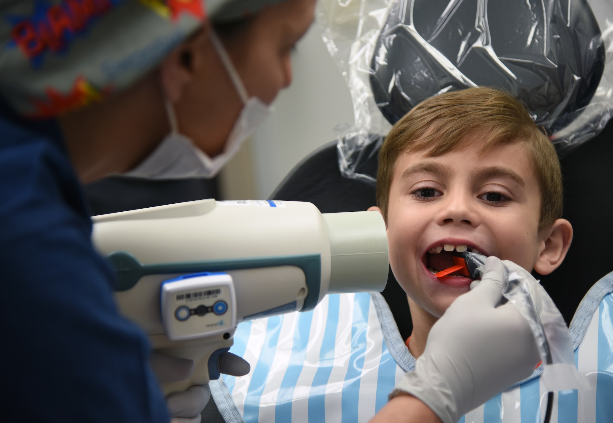 Regina Yarbrough, 81st Dental Squadron dental technician, conducts an X-ray exam on Raylan Wanhala, son of U.S. Air Force Tech. Sgt. Daniel Wanhala, 81st Security Forces Squadron flight chief, during the 9th Annual Give Kids a Smile Day at the dental clinic inside the Keesler Medical Center at Keesler Air Force Base, Mississippi, Feb. 15, 2019. The event was held in recognition of National Children’s Dental Health Month and included free dental exams, radiographs and cleanings for children age two and older for more than 60 children. The clinic provided approximately $16,000 in care during the free screening. (U.S. Air Force photo by Kemberly Groue)