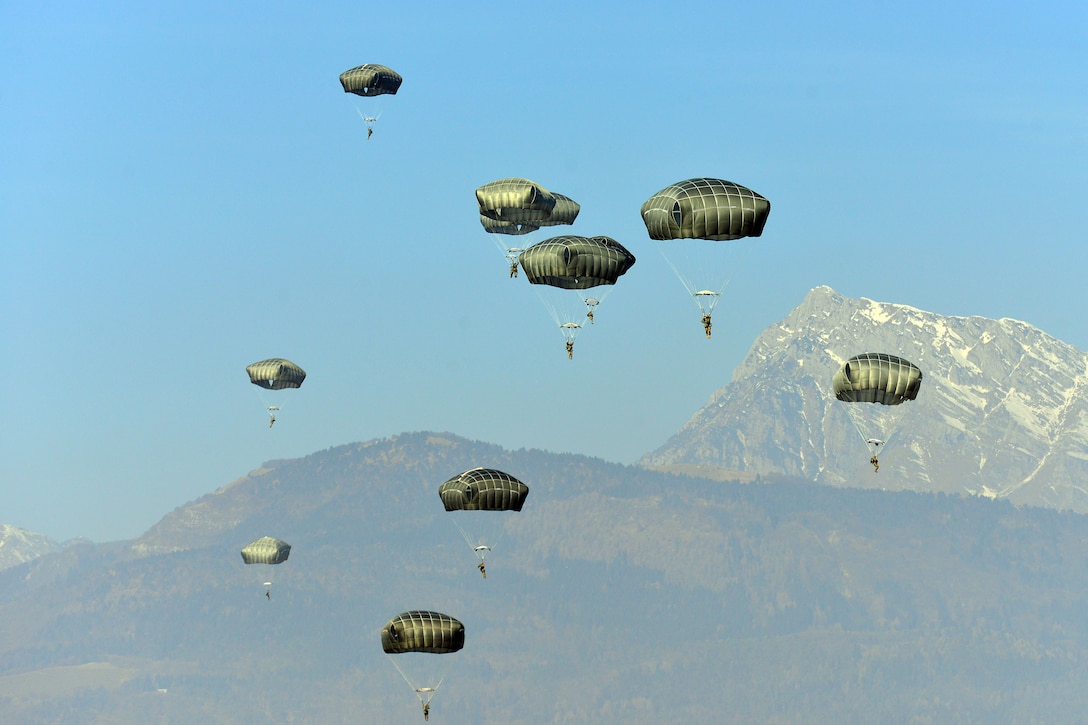 Paratroopers land on a drop zone.