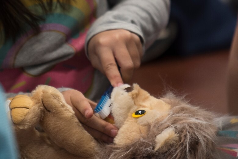 A child practices brushing teeth on an interactive toy at a Children’s Dental Health Month event at Cannon Air Force Base, N.M., Feb. 21, 2019. During the event, children were able to partake in multiple hands-on activities to learn about dental hygiene. (U.S. Air Force Photo by Airman 1st Class Vernon R. Walter III)