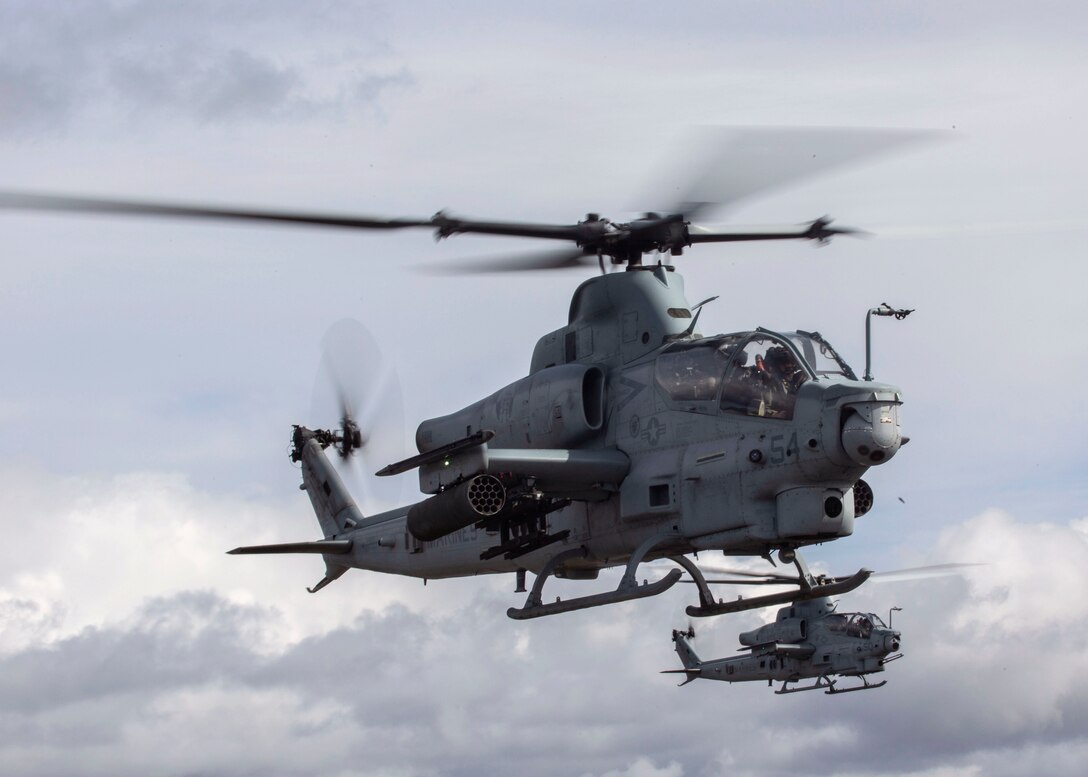 Two AH-1Zs with Marine Light Attack Squadron (HMLA) 469, Marine Aircraft Group (MAG) 39, 3rd Marine Aircraft Wing (MAW), fly over Marine Corps Air Station Camp Pendleton, Calif., during a training exercise, Feb. 15. In a dynamic display of strength, MAG-39, launched 82 attack, utility and assault support aircraft. Maintainers and ground support crews watched with pride and a strong sense of accomplishment as each of their aircraft fulfilled its role in formation, took to the sky, then disappeared over the horizon. Over the course of several hours, more than 100 aircraft from MAG-13 and MAG-39 took to the skies over Southern California, proving 3rd MAW’s capability to “Fix, Fly, Fight” and, when needed advance at a moment’s notice. (U.S. Marine Corps photo by Cpl. Samuel Ruiz)