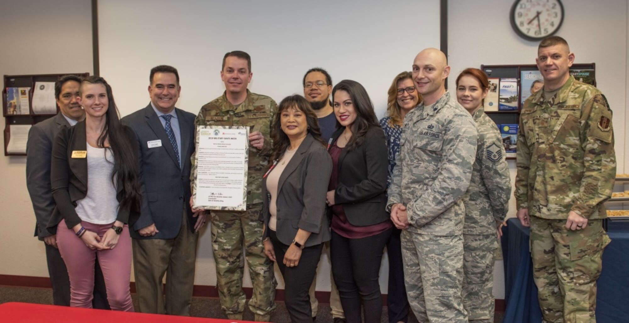 U.S. Air Force Col. Jeffrey Nelson, 60th Air Mobility Wing commander, holds a proclamation designating Feb. 25 through March 1, 2019 Military Saves Week at the Airman and Family Readiness Center, Feb. 21, 2019, Travis Air Force Base, California. The Military Saves Week program encourages Airman to save for the future and to reduce debt. The event is a team effort between the A&FRC, Travis Credit Union and Armed Forces Bank. (U.S. Air Force Photo by Heide Couch)