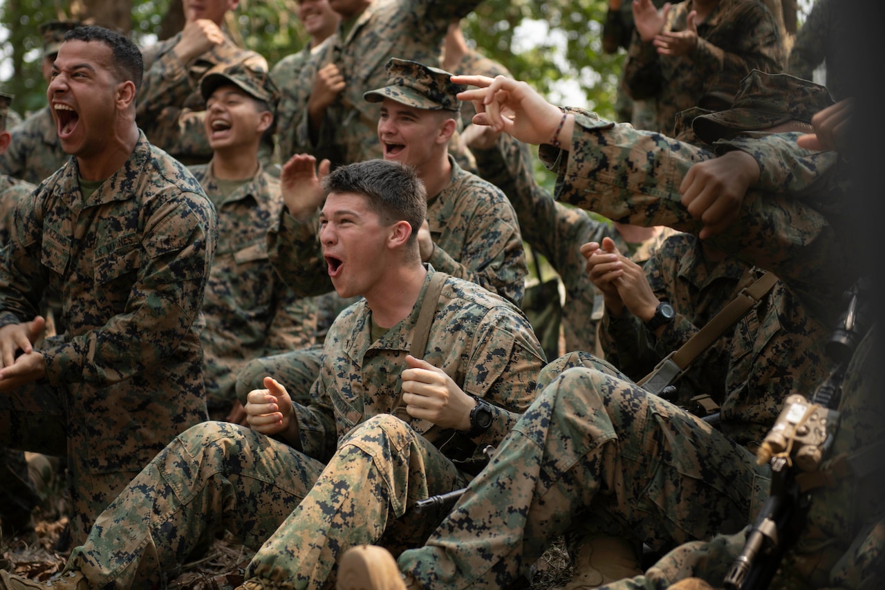 A group of Marines cheer during jungle training.