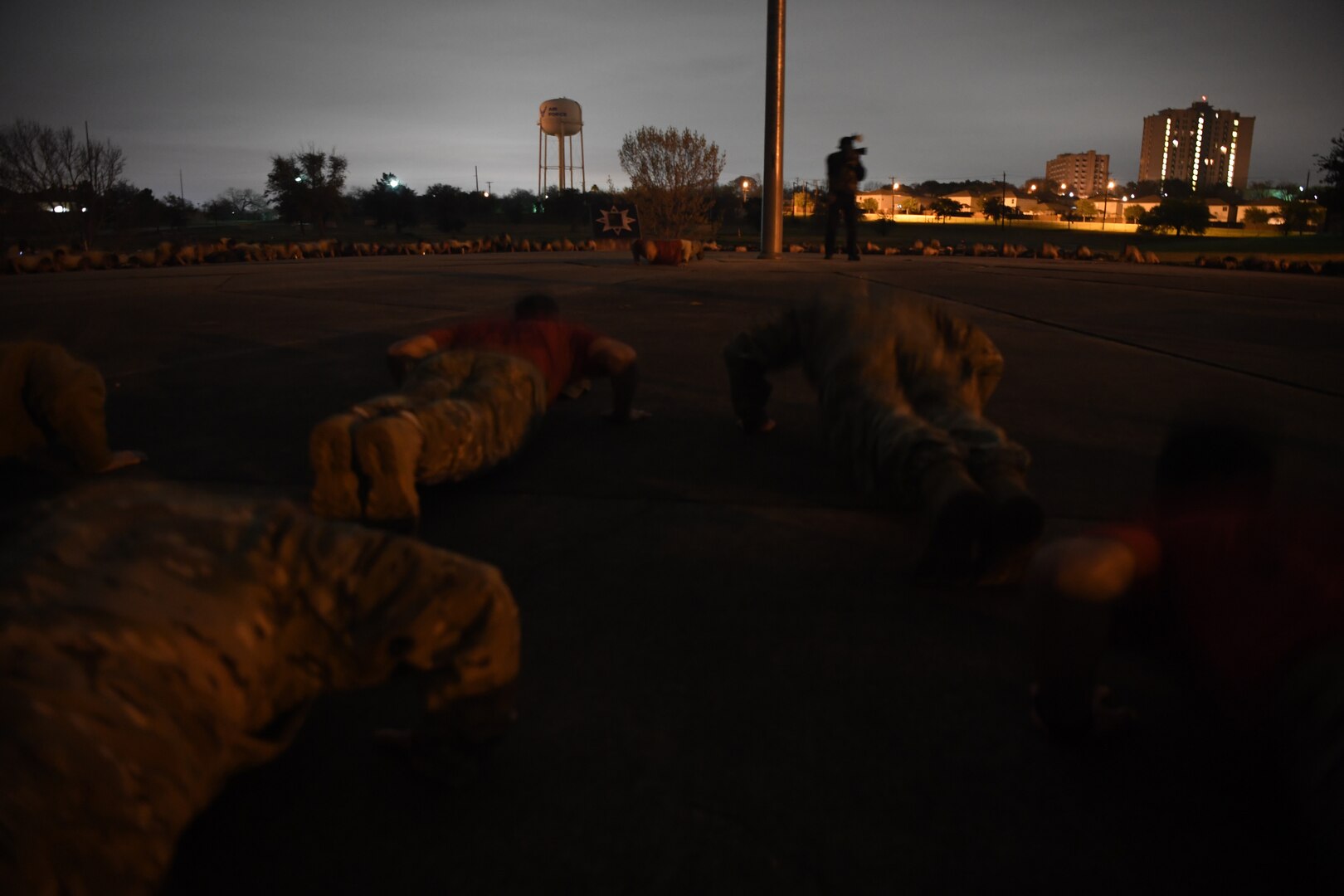 Hundreds of Special Tactics Airmen, trainees, and supporters perform memorial pushups to kick off the Special Tactics Memorial March Feb. 22, 2019, at Lackland Air Force Base, Texas.