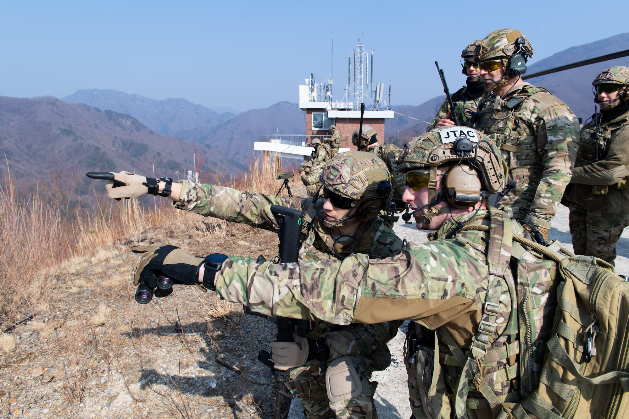 U.S. Air Force joint terminal attack controllers assigned to the 604th Air Support Operations Squadron and 607th Air Support Operations Group make an assessment prior to calling in an A-10 Thunderbolt II strafing run during close air support training at the Pilsung Range in Gangwan Province, Republic of Korea, Feb. 14, 2019.