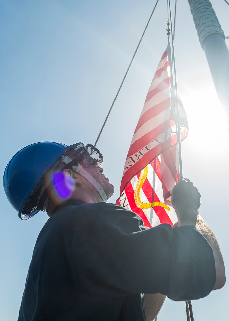 190223-N-WI365-1088 KOTA KINABALU, Malaysia (Feb. 23, 2019) – Boatswain’s Mate 3rd Class Ralph Giansanti, from Avon, Conn., raises the Navy Jack on the foc’s’le of the amphibious dock landing ship USS Ashland (LSD 48) during a sea and anchor evolution. Ashland, part of the Wasp Amphibious Ready Group, with embarked 31st Marine Expeditionary Unit, is operating in the Indo-Pacific region to enhance interoperability with partners and serve as a ready-response force for any type of contingency. (U.S. Navy photo by Mass Communication Specialist 2nd Class Markus Castaneda)