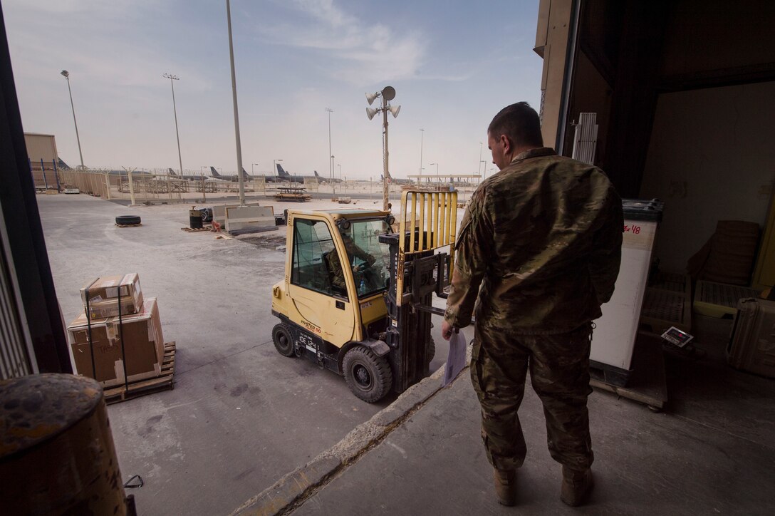 Senior Airman Bill Tilton, 379th Expeditionary Logistics Readiness Squadron (ELRS) traffic management office (TMO) traffic management journeyman, prepares to receive assets Feb. 22, 2019, at Al Udeid Air Base, Qatar. The 379th ELRS TMO handles the pick-up, storage, shipment, and delivery of assets such as small vehicle parts, aircraft engines, and clothing items throughout the U.S. Central Command area of responsibility. (U.S. Air Force photo by Tech. Sgt. Christopher Hubenthal)
