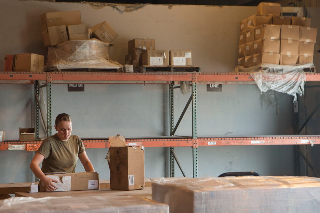 Tech. Sgt. Brittany Dorsett, 379th Expeditionary Logistics Readiness Squadron (ELRS) traffic management office (TMO) inbound cargo NCO in charge, organizes packages Feb. 22, 2019, at Al Udeid Air Base, Qatar. The 379th ELRS TMO handles the pick-up, storage, shipment, and delivery of assets such as small vehicle parts, aircraft engines, and clothing items throughout the U.S. Central Command area of responsibility. (U.S. Air Force photo by Tech. Sgt. Christopher Hubenthal)