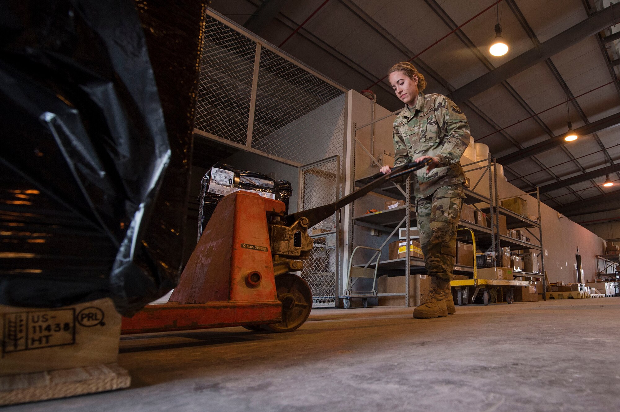 Senior Airman Chelsey Burkus, 379th Expeditionary Logistics Readiness Squadron (ELRS) traffic management office (TMO) traffic management journeyman, prepares to move a pallet Feb. 22, 2019, at Al Udeid Air Base, Qatar. The 379th ELRS TMO handles the pick-up, storage, shipment, and delivery of assets such as small vehicle parts, aircraft engines, and clothing items throughout the U.S. Central Command area of responsibility. (U.S. Air Force photo by Tech. Sgt. Christopher Hubenthal)