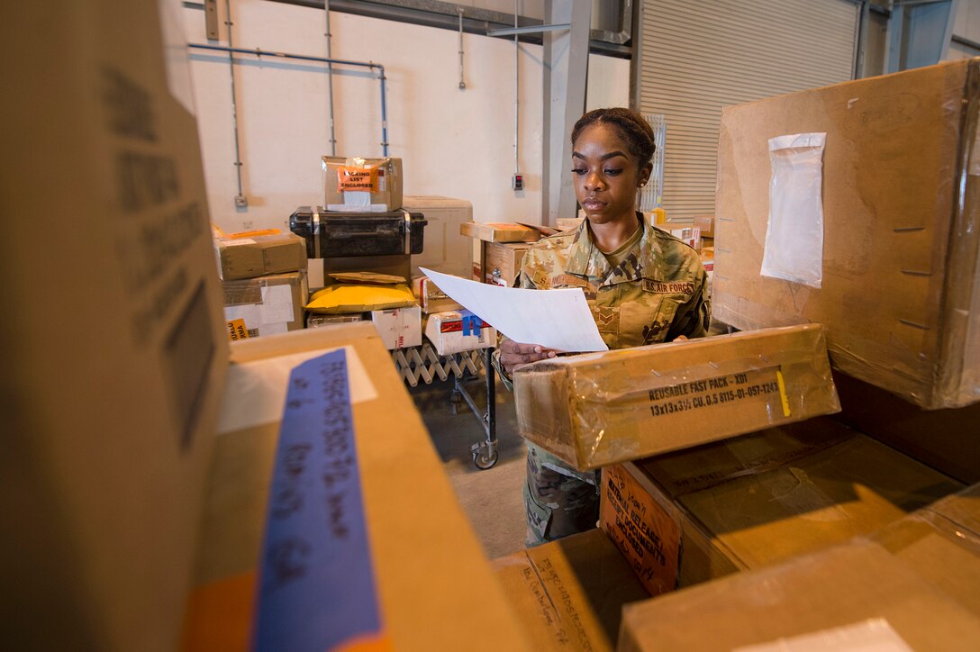 Senior Airman Zhynae Sanchez, 379th Expeditionary Logistics Readiness Squadron (ELRS) traffic management office (TMO) shipment planning technician, verifies data on outbound cargo Feb. 23, 2019, at Al Udeid Air Base, Qatar. The 379th ELRS TMO handles the pick-up, storage, shipment, and delivery of assets such as small vehicle parts, aircraft engines, and clothing items throughout the U.S. Central Command area of responsibility. (U.S. Air Force photo by Tech. Sgt. Christopher Hubenthal)