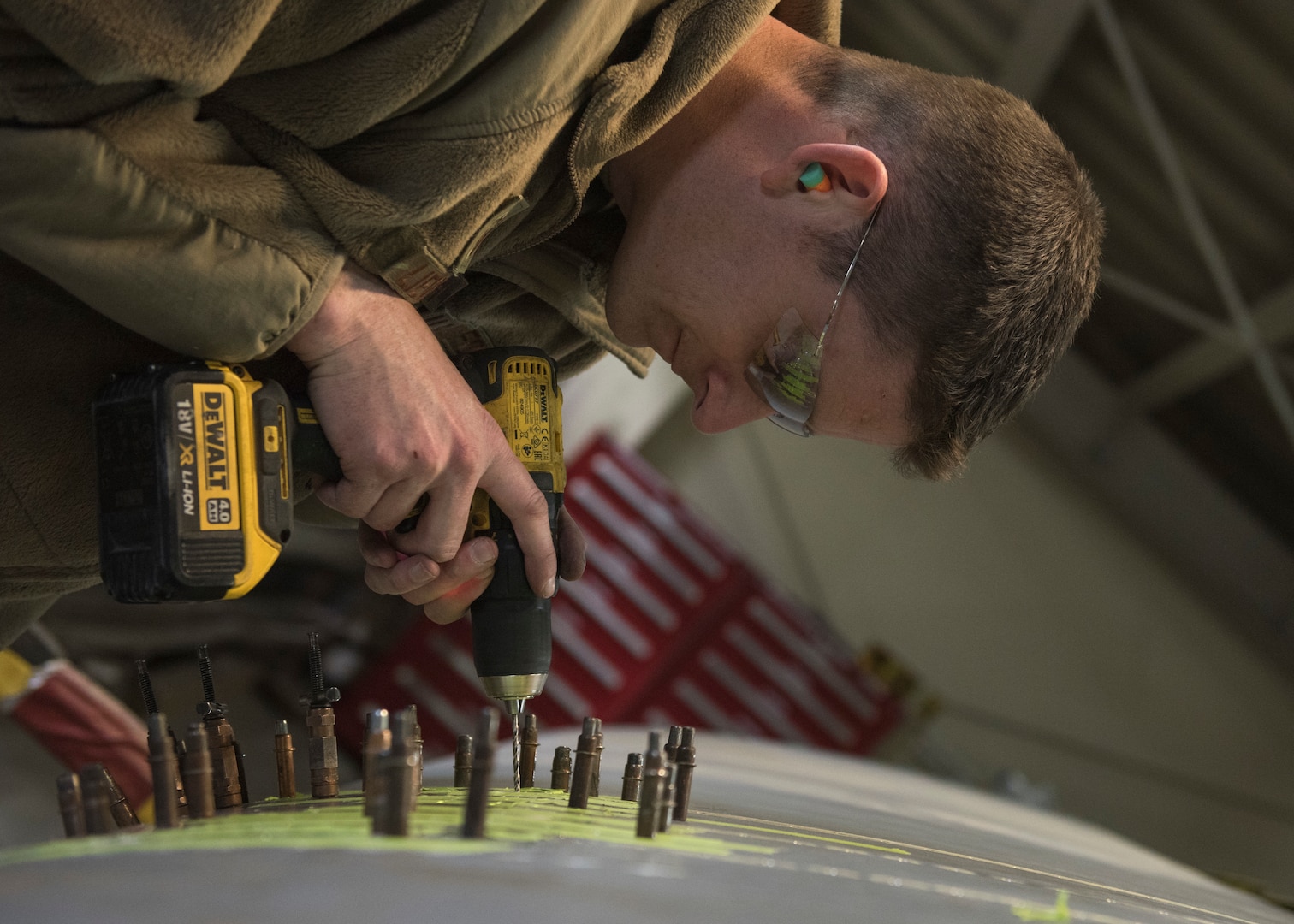 Master Sgt. Andrew Liederbach, 386th Expeditionary Maintenance Squadron combat metals flight chief, inserts temporary placeholders where the rivits will be placed after the permanent patch is complete at an undisclosed location in Southwest Asia, Feb. 6, 2019. When the damage first occurred, Liederbach and his team got their tools and materials together to fly to the aircraft to place a temorary patch on the wing to get it back to base for a permanent repair.
